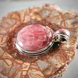 Rhodochrosite sterling silver round pendant with inlaid bail