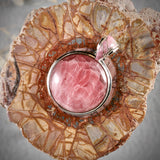 Rhodochrosite sterling silver round pendant with inlaid bail